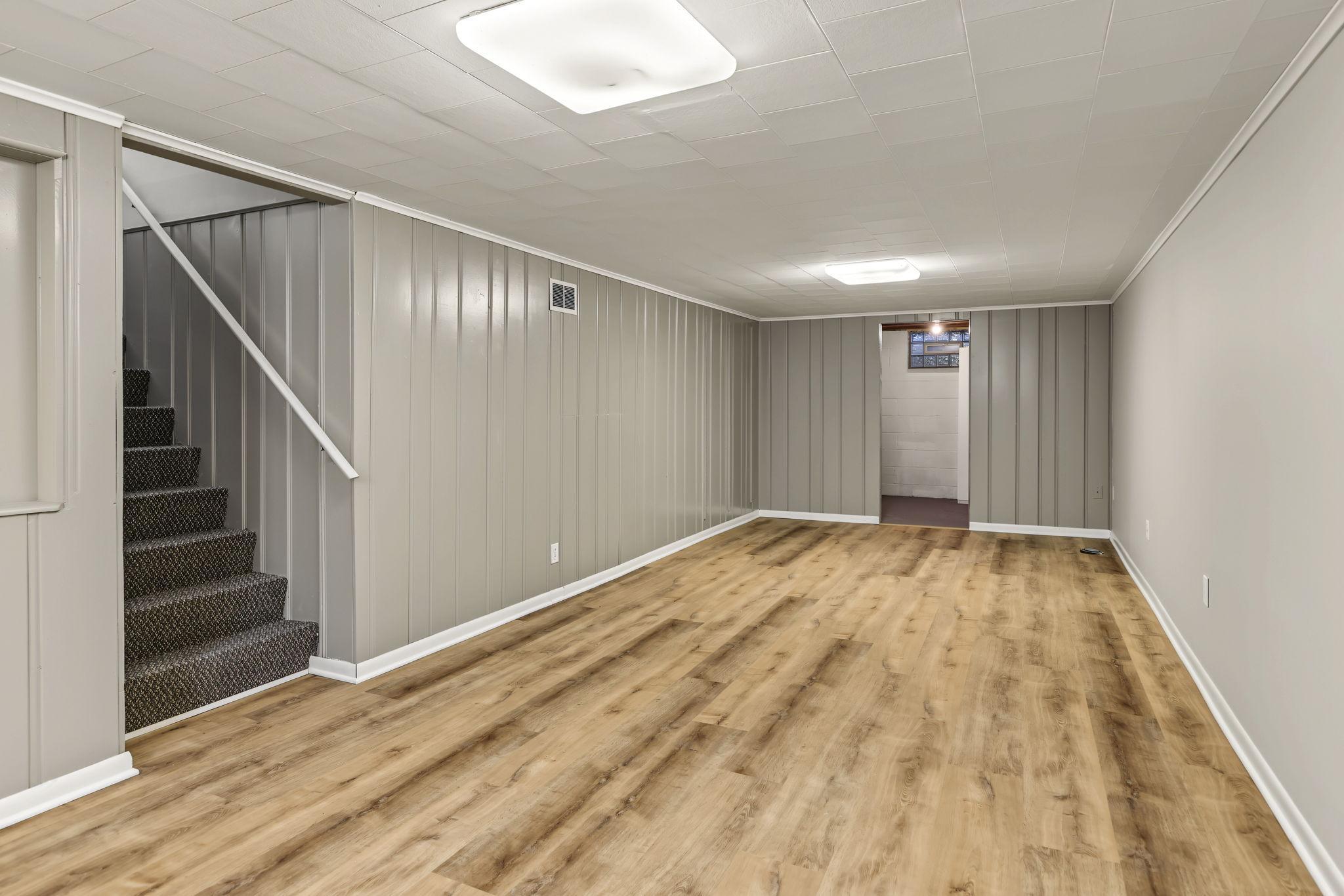 Lower level family room with new flooring and paint