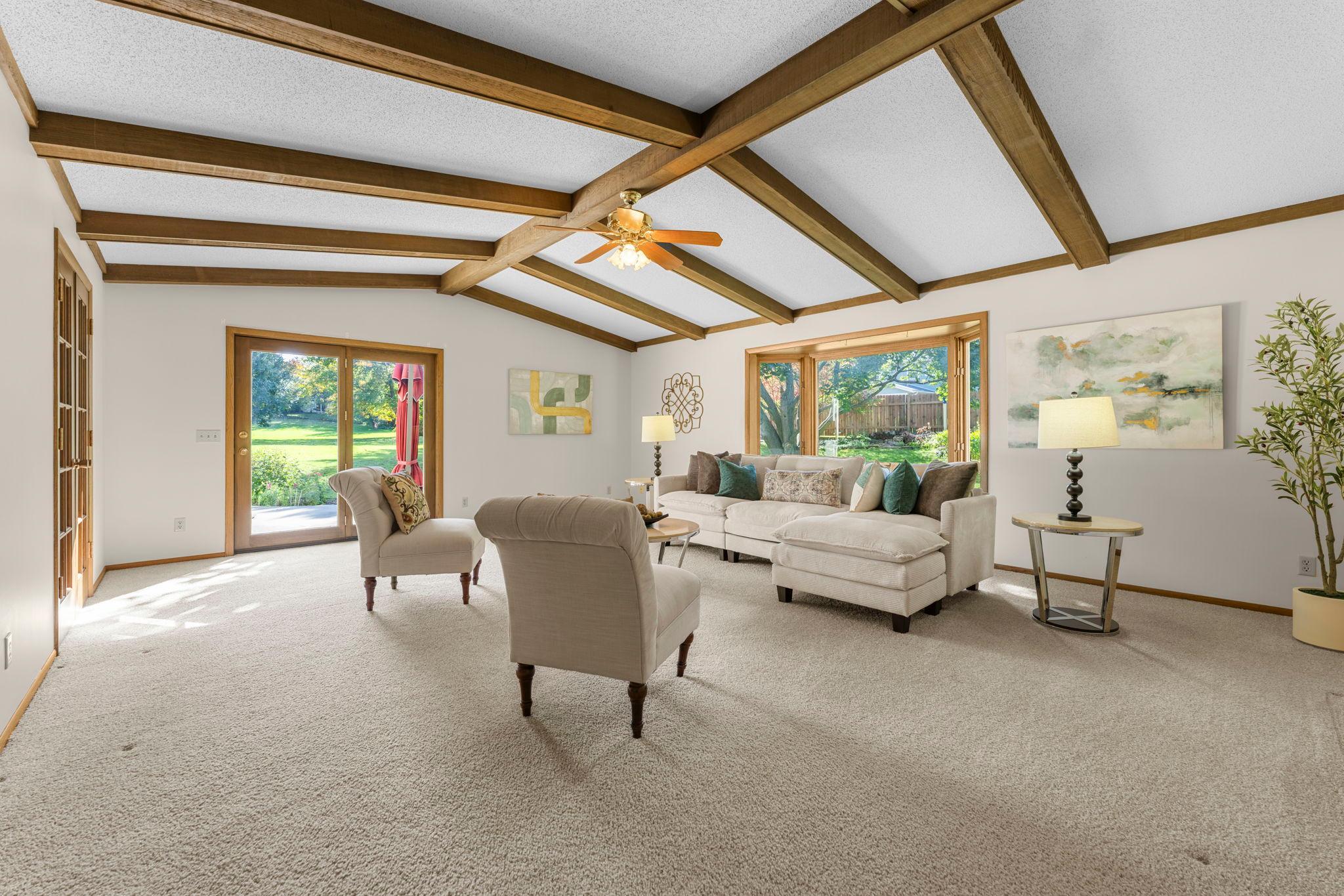 Spacious living area with beamed ceiling