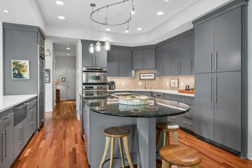 Gourmet kitchen with granite island, stainless appliances, custom cabinetry