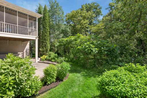 Private walkout patio surrounded by mature trees