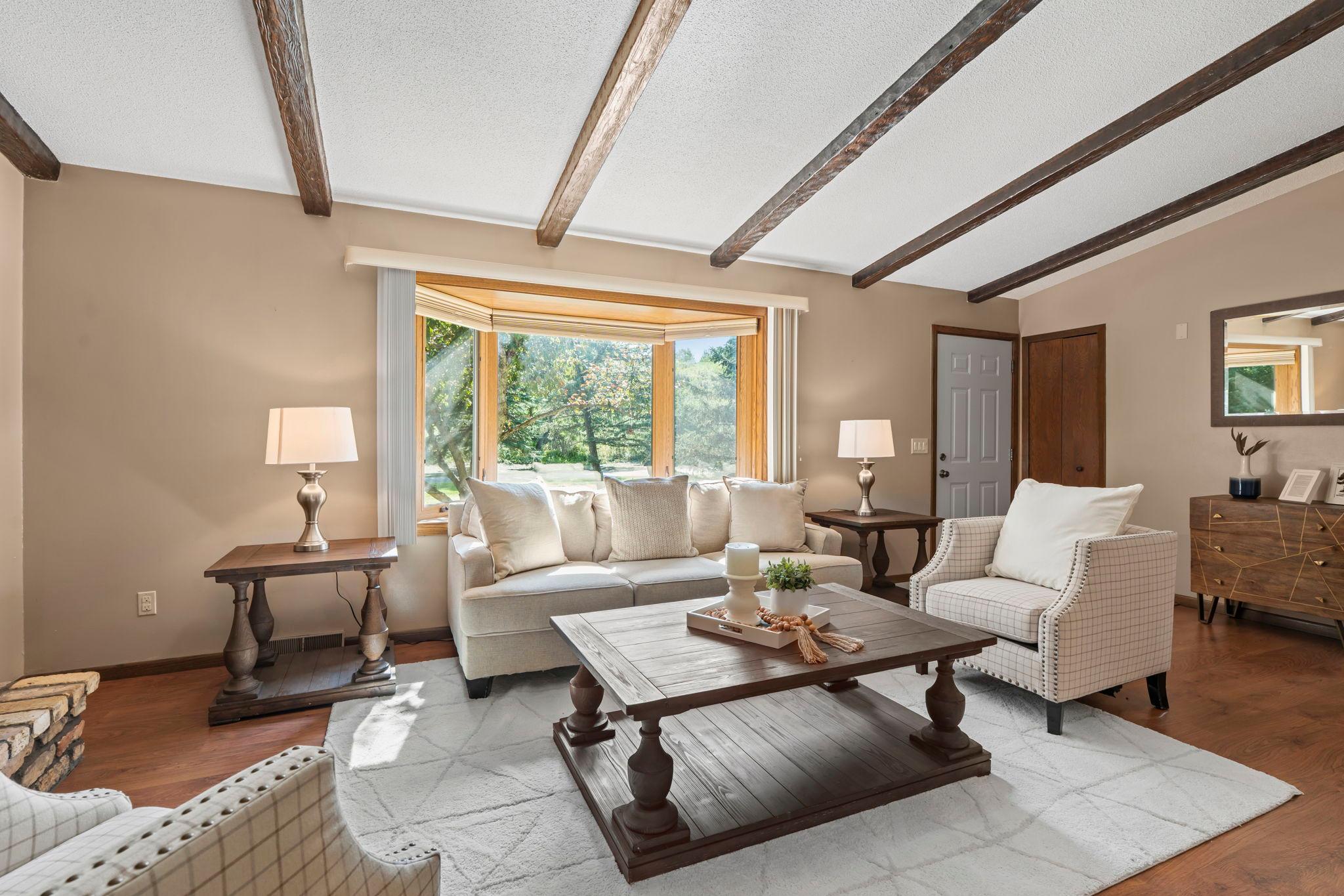 Stunning living room complete with open floorplan and a bay window overlooking the front yard.