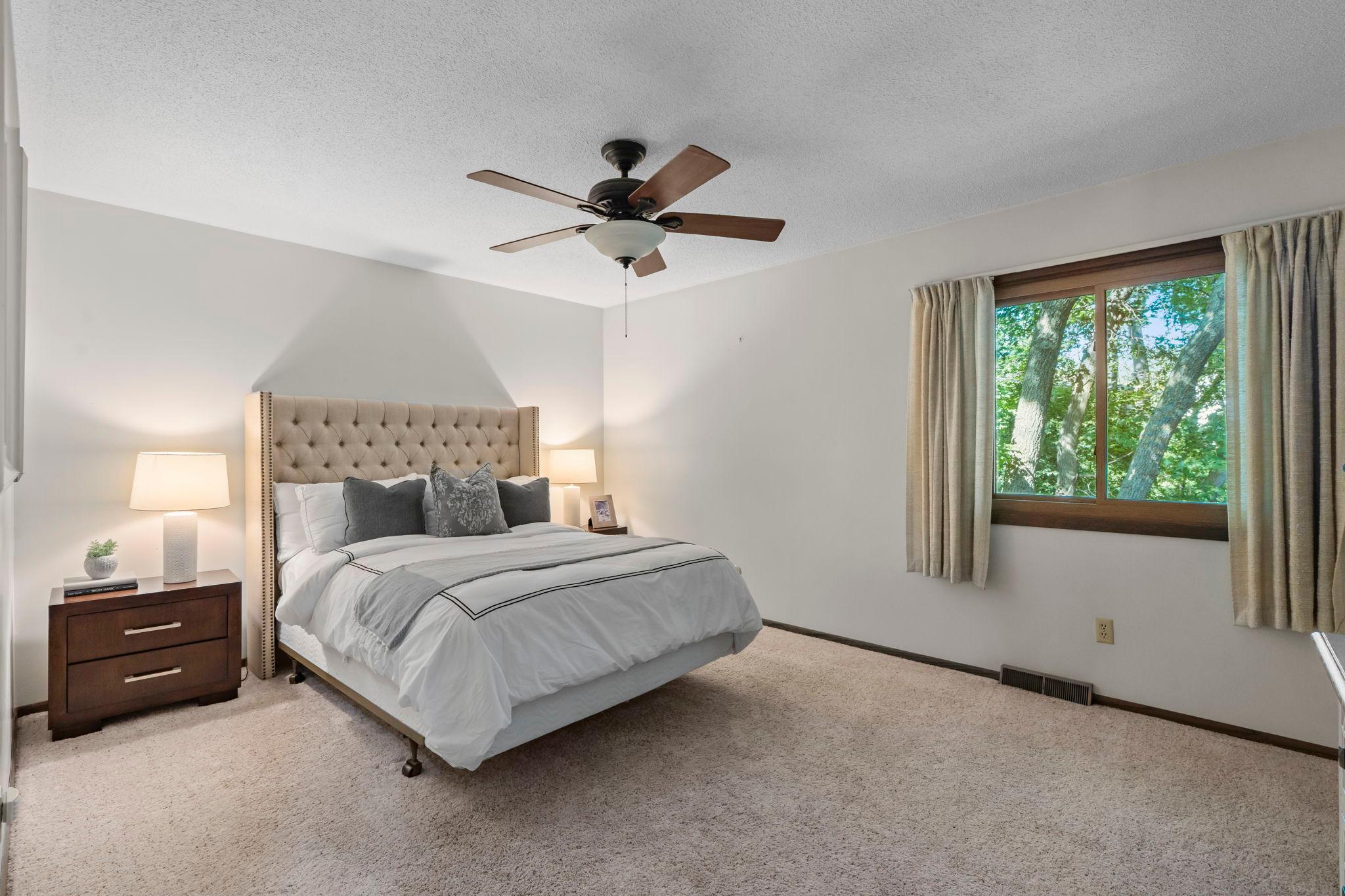 Spacious primary bedroom on the main level with backyard veiws.