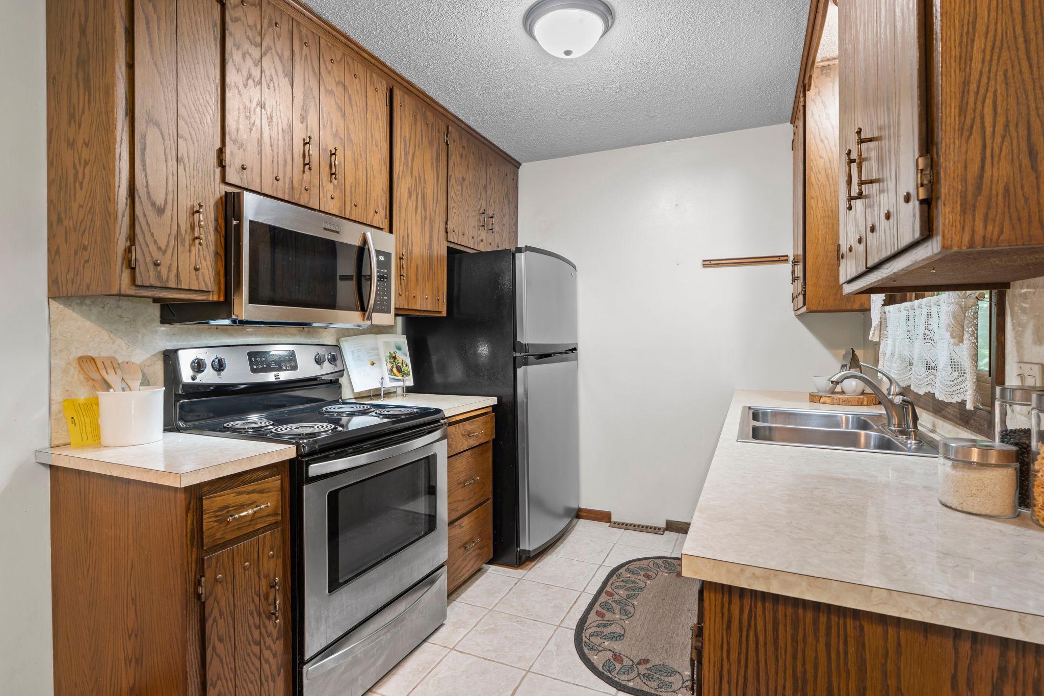 Kitchen complete with stainless steel appliances including a gas stove.