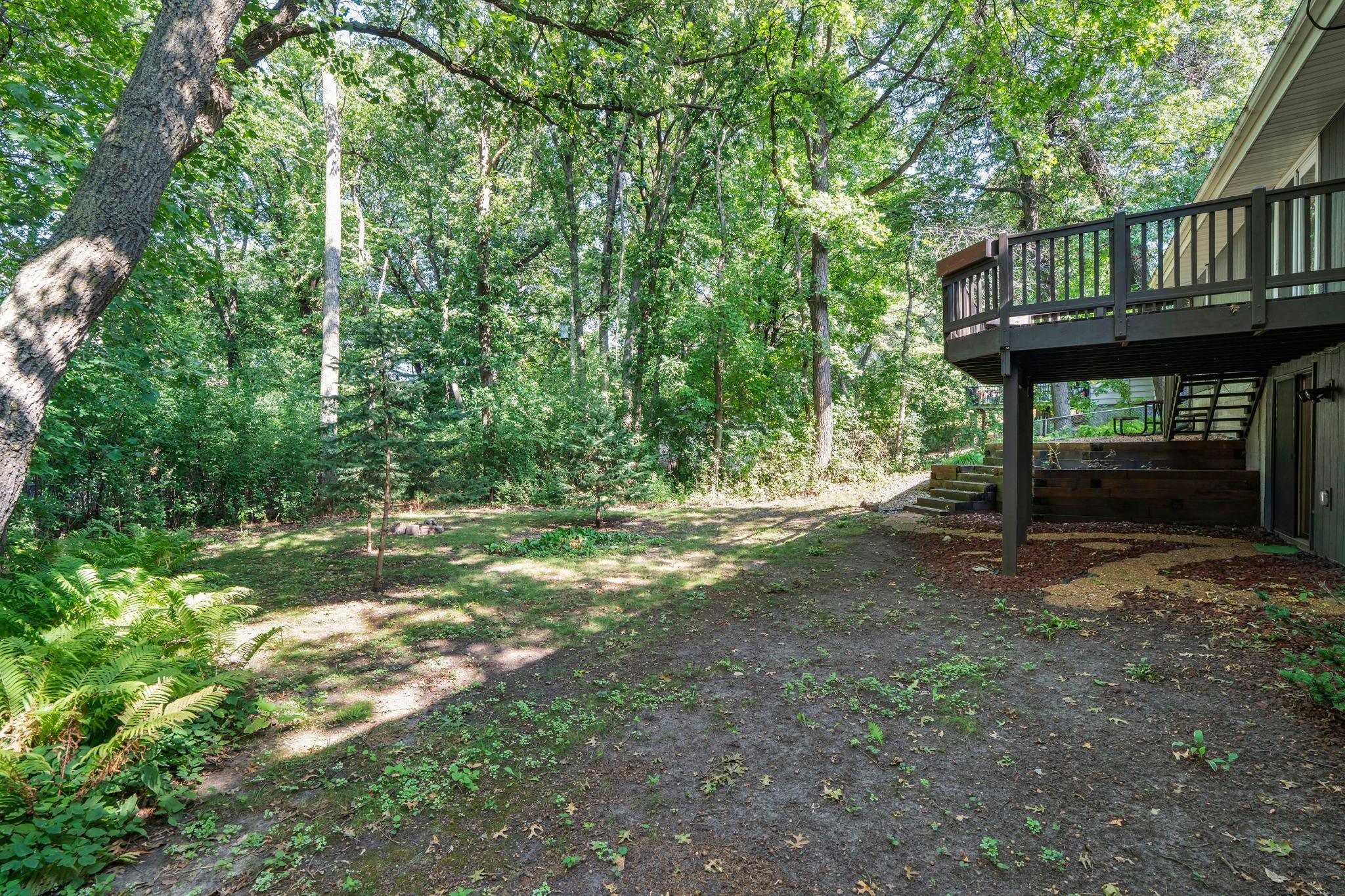 Wooded backyard offering privacy and your own future retreat.