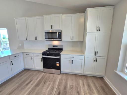 The Rushmore Kitchen shown with White cabinets at Highlands at Eagle View in Elko New Market. Photo is of actual home. Options and colors may vary. Ask Sales Agent for details.
