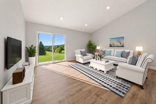 The home's main level living space is loaded with space, and can accommodate just about any family room furniture set-up. Photo is of similar staged home. Colors and options may vary. Ask Sales Agent for details.