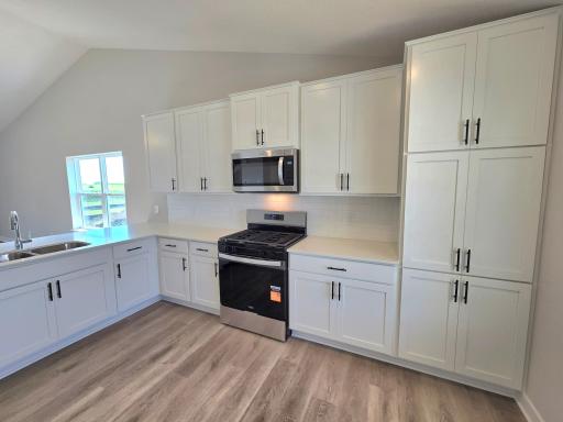 The Rushmore Kitchen shown with White cabinets at Highlands at Eagle View in Elko New Market. Photo is of actual home. Options and colors may vary. Ask Sales Agent for details.