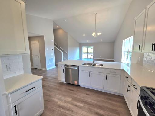 The Rushmore Kitchen shown with White cabinets at Highlands at Eagle View in Elko New Market. Photo is of actual home. Options and colors may vary. Ask Sales Agent for details.