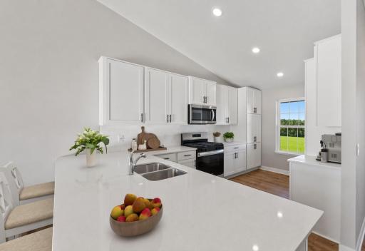 One of the first things you'll notice is our attention to detail throughout the layout, especially here in the kitchen! Photo is of similar staged home. Colors and options may vary. Ask Sales Agent for details.
