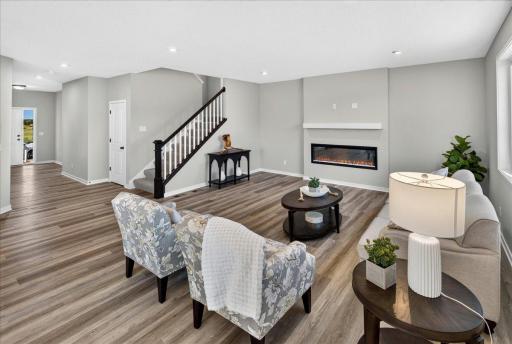 PHOTO OF A DIFFERENT HOME WITH SIMILAR PLAN AND FINISHES. Great Room features a Fireplace with Mantel.