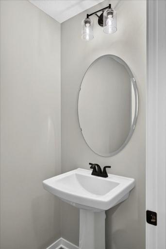 PHOTO OF A DIFFERENT HOME WITH SIMILAR PLAN AND FINISHES. Half Bath.
