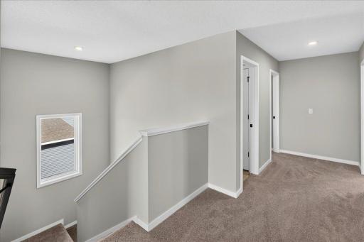 PHOTO OF A DIFFERENT HOME WITH SIMILAR PLAN AND FINISHES. Upper Hallway.