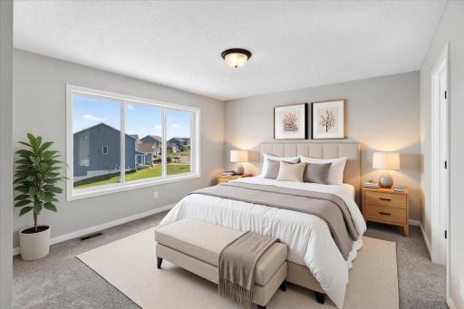 PHOTO OF A DIFFERENT HOME WITH SIMILAR PLAN AND FINISHES VIRTUALLY STAGED. Primary Suite features large window views to the backyard.