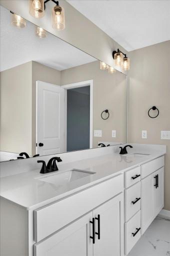 PHOTO OF A DIFFERENT HOME WITH SIMILAR PLAN AND FINISHES. Primary Suite Deluxe Bath features a Double Sink Vanity with Soft Close Doors and Drawers.