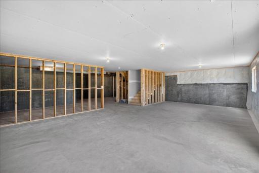 PHOTO OF A DIFFERENT HOME WITH SIMILAR PLAN AND FINISHES. Unfinished Walkout Lower Level.