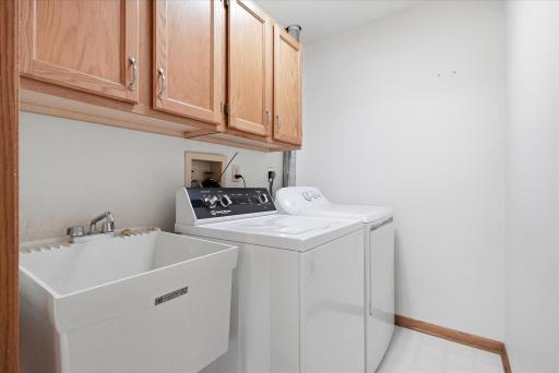 Lower level Laundry Room w/washer and electric dryer and convenient wet sink