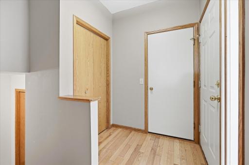 Inviting Entry w/hardwood flooring w/stairs to upper/lower levels, closet and door to garage