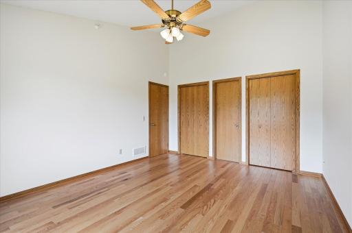 Primary Bedroom Suite features hardwood floors, walkthru Full Bathroom and large closet