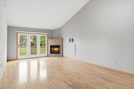 Vaulted Living Room features beautiful hardwood floors, gas fireplace w/oak mantel shelf, ceiling fan/light and patio door to main-free deck. Great summer indoor and outdoor spaces for entertaining with friends and family