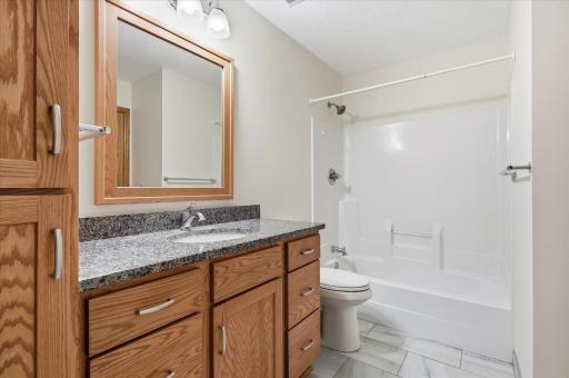 Remodeled Upper Level Walk-thru Full Bathroom with tile floor and linen closet includes updated higher top vanity w/granite counter tops, updated lighting, mirror and faucet