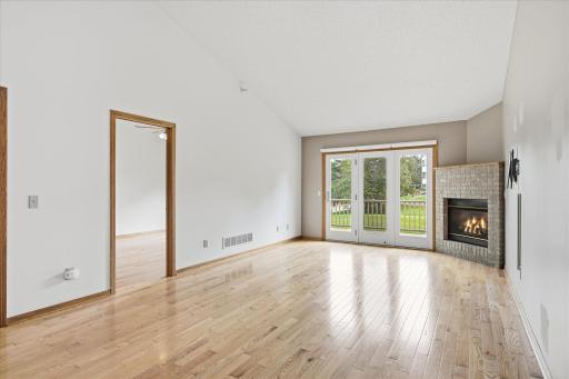 Vaulted Living Room features beautiful hardwood floors, gas fireplace w/oak mantel shelf, ceiling fan/light and patio door to main-free deck. Great summer indoor and outdoor spaces for entertaining with friends and family