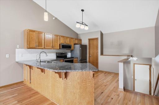 Remodeled Kitchen includes granite counter tops, undermount ss sink, white tile backsplash, ss appliances, breakfast bar counter w/pendant light and huge walk-in pantry