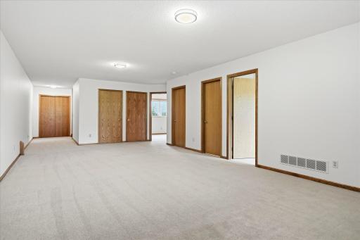 Spacious lower level 27ft long Family Room with new carpet and lookout Anderson windows. Could be divided into two separate areas for flexible living space for entertaining