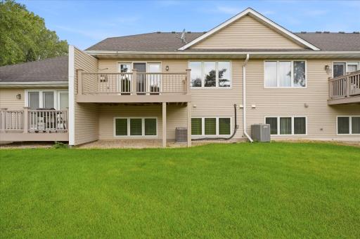 Rearview of the deck and lower level lookout windows. Irritation system controlled by HOA keeps the lawn green