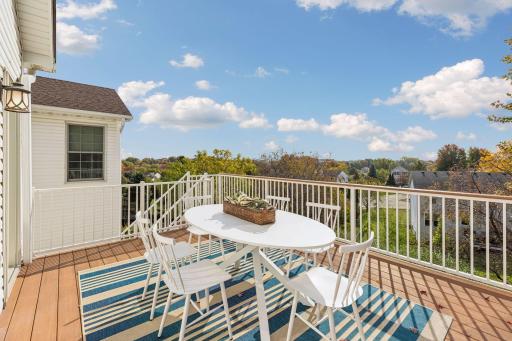 Enjoy outdoor dining and beautiful views of the lot from the spacious deck, with stairs leading to the patio outside the walkout lower level.