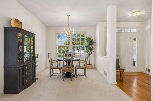 The dining room sits just off the front entry and connects to the living room, with a large window overlooking the front yard.
