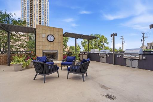 Pool Deck with Fire Place, Plenty of Seating, and Grills