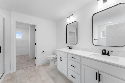 The en-suite bathroom has dual sinks to simplify any morning routine