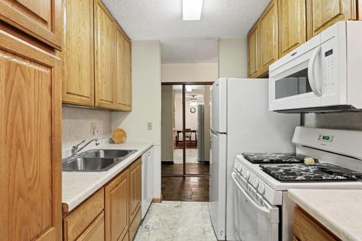 Galley-Style Kitchen with ample cabinetry, countertop space, and an adjacent dining area.