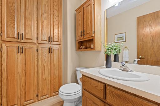 Main level half bath plumbed for a future full bath where the built-in storage is currently located.