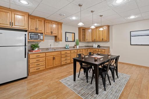 With a refrigerator, microwave, sink, and extensive cabinetry, this space is ready for game days and gatherings.