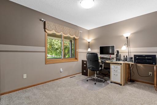 Main level bedroom 1 currently set up as an office.