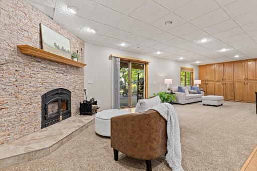 A second wood-burning fireplace creates a cozy focal point downstairs.