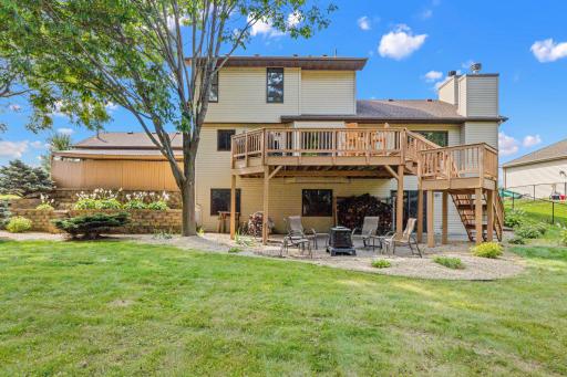 The backyard offers multiple places to gather, from the elevated deck to the patio below.
