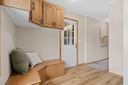 A side entrance from the porch leads directly into the mudroom with built-in storage.