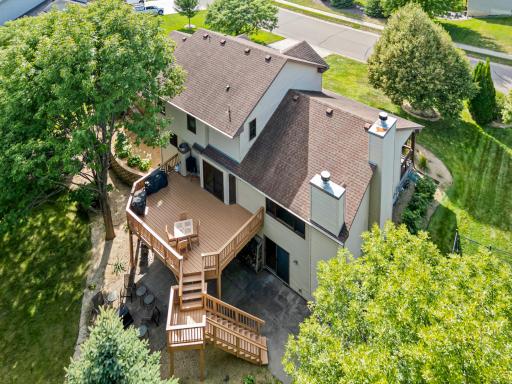 Aerial views showcase the home, expansive outdoor living spaces, and mature surroundings.