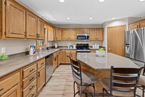 The large center island becomes a natural gathering place for morning coffee, casual meals, and conversation.