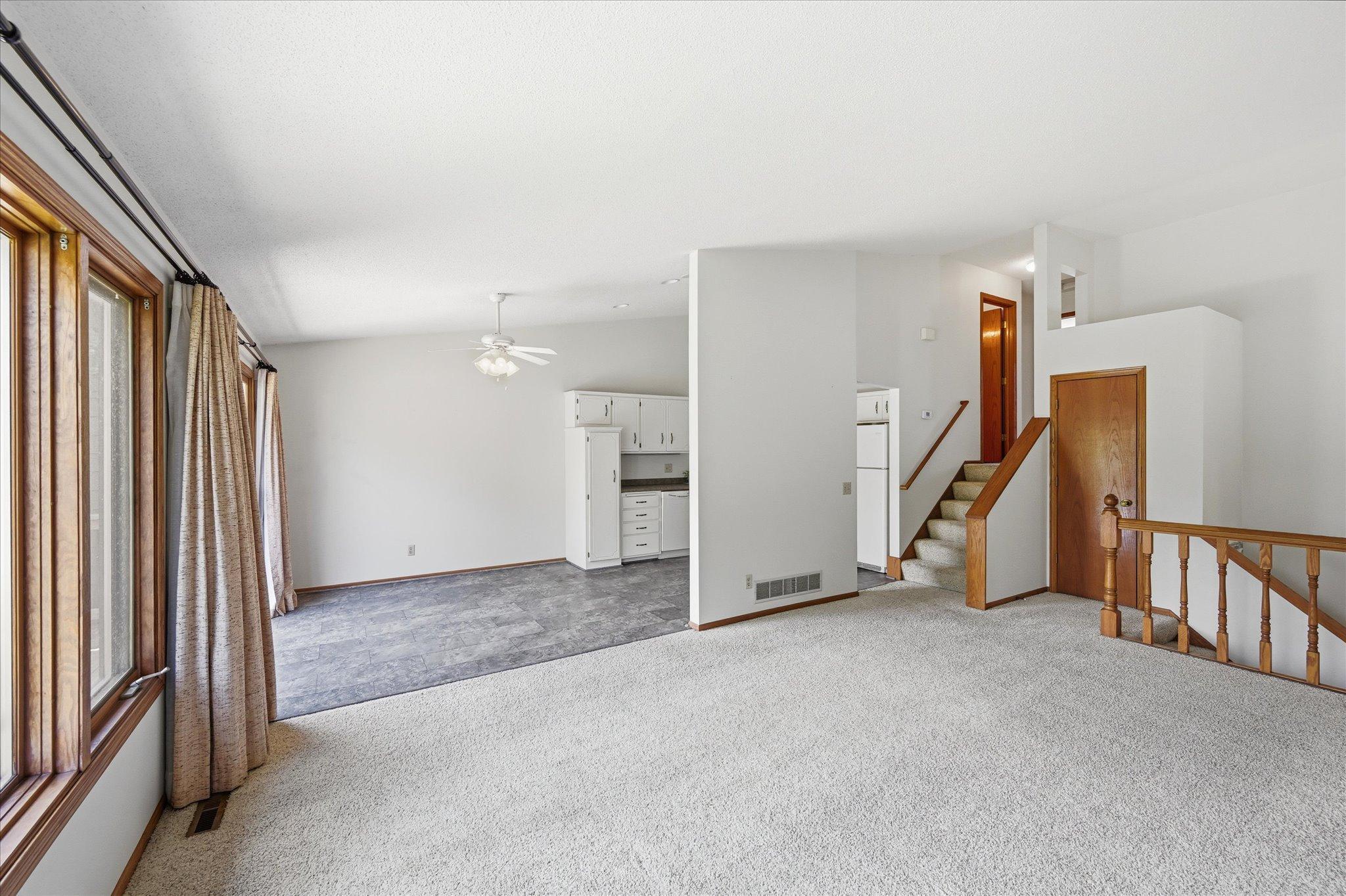 Vaulted ceilings and expansive windows create an open, airy atmosphere filled with natural light.