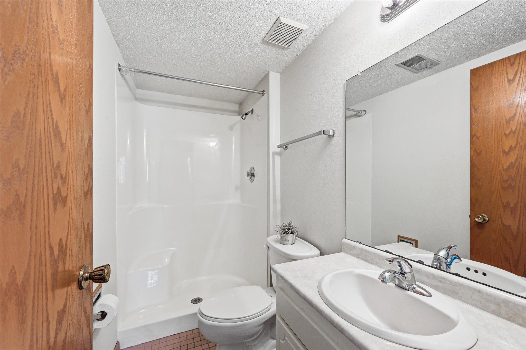 The lower-level bathroom adds convenience to the home's thoughtful floor plan.
