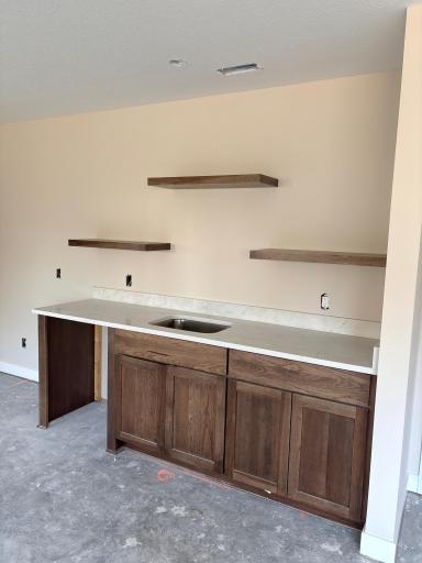 Wet bar in LL Family room with floating shelfs