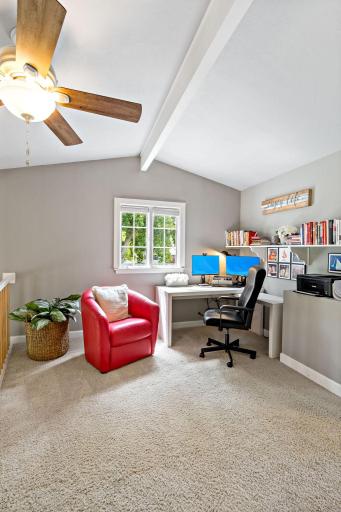 A bright loft office with vaulted ceilings — a functional workspace with room to unwind between meetings