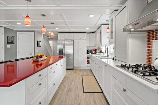 Color and personality theme this crisp white chef's kitchen.