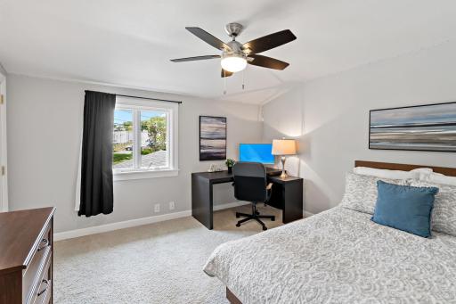 A spacious secondary bedroom with room for a built-in desk area — flexible space for guests, family, or working from home