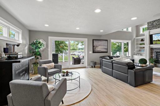 Comfortable seating flows straight out to the deck, with sightlines to the marina beyond — perfect for indoor-outdoor lake living