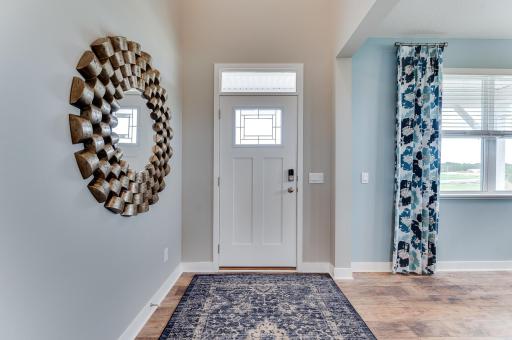 Your guests will enter through the front door of the home and immediately be impressed with the spacious foyer. Photos of model home, colors and finishes may vary.