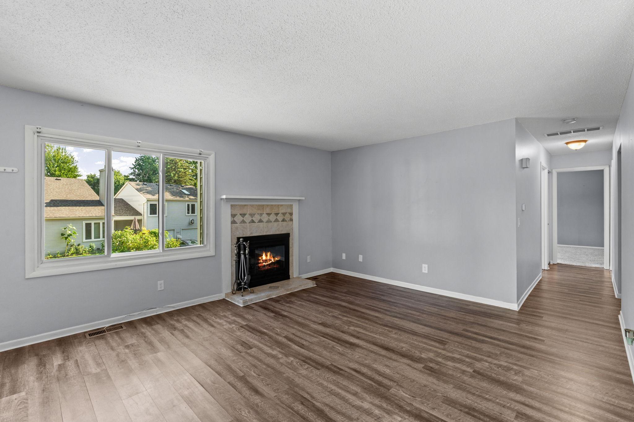 South facing windows fill the home with natural light. Wood burning fireplace